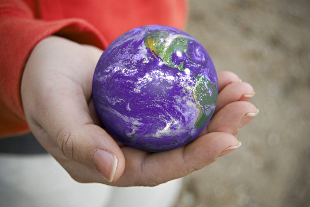 a conceptual image with the earth resting in the palm of this persons hand SFBlScPASo