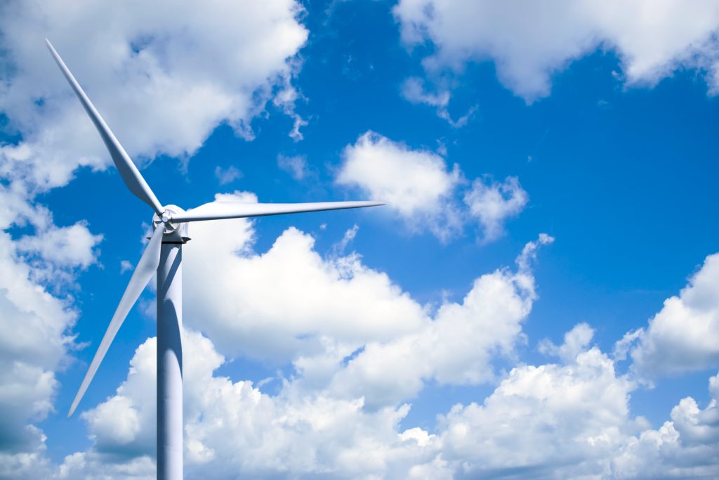 a single wind turbine over a cloud filled blue sky BF0 uG 0Hj