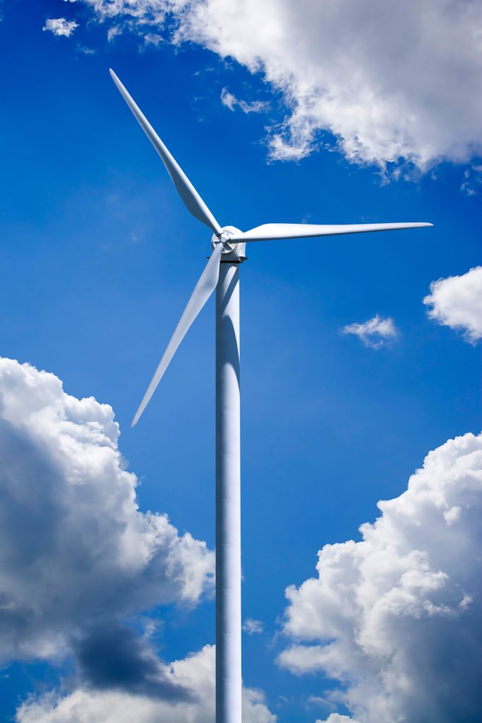 a single wind turbine over a cloud filled blue sky clipping path is included for easy isolation of the turbine HtJr Ari 1