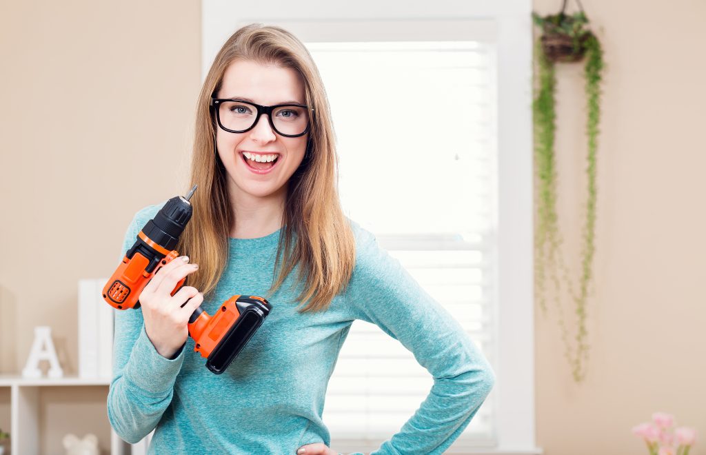 graphicstock young woman with cordless drill ready for home repairs BKJxgA9dXd