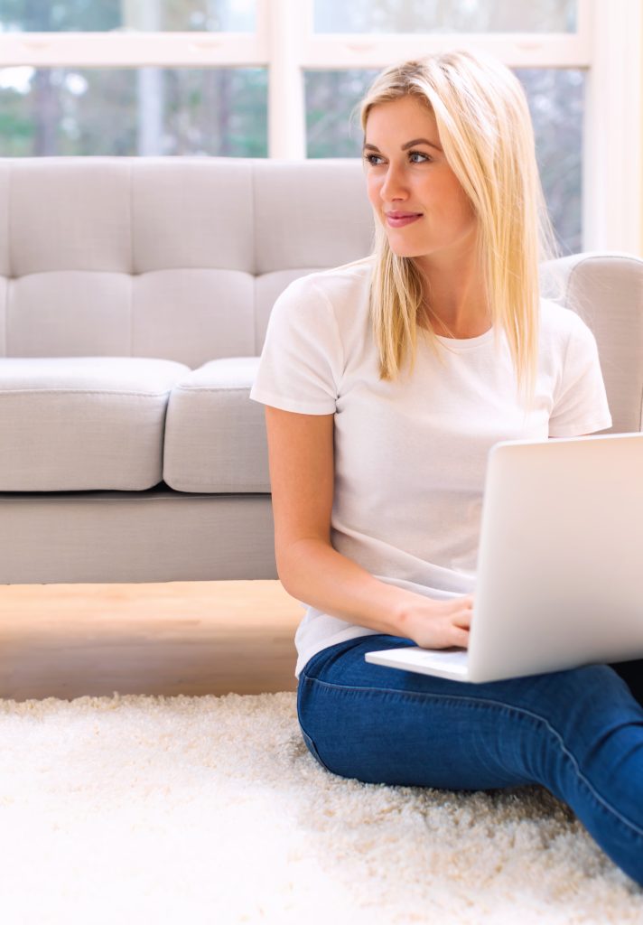 graphicstock happy young woman using her laptop at home SttzJSjuQ Z